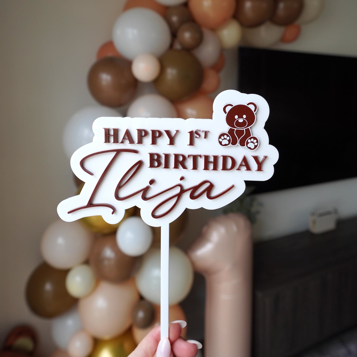 white and brown acrylic cake topper that says happy 1st birthday Ilija